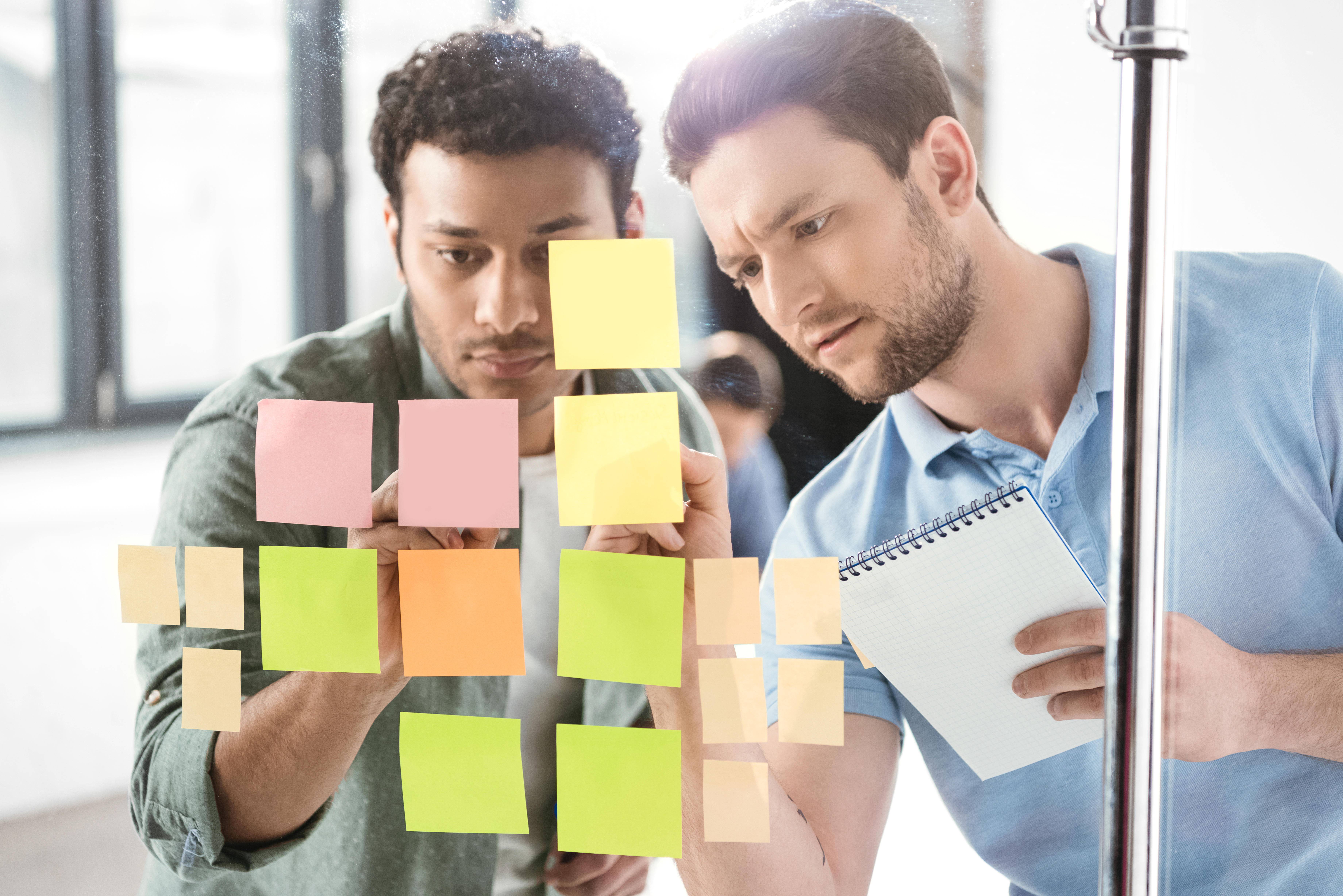 Depositphotos_152079742_xl-2015 (2 men working with post its)-1
